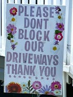 EXEMPLARY SIGN: This sign, using gentleness, not anger, was put up by a property owner in a part of Whitney Pier with frequent on-street parking. The sign uses a courteous, friendly, artful appeal in response to an ongoing concern of residents. It avoids stark hostility. The property owner was also clearly conscious that many children will be reading this. Photo by Tom Urbaniak