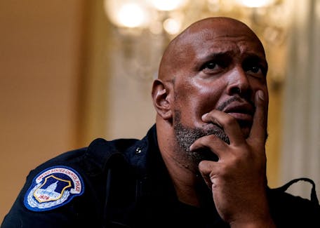 U.S. Capitol Police officer Harry Dunn watches a video played during a public hearing of the U.S. House Select Committee to investigate the January 6 Attack on the U.S. Capitol, on Capitol Hill in Washington, U.S., October 13, 2022.