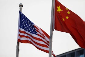 Chinese and U.S. flags flutter outside the building of an American company in Beijing, China January 21, 2021.