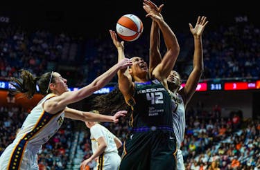 May 14, 2024; Uncasville, Connecticut, USA; Indiana Fever guard Caitlin Clark (22) and forward Aliyah Boston (7) defend against Connecticut Sun forward Brionna Jones (42) in the second half at Mohegan Sun Arena. Mandatory Credit: David Butler II-USA TODAY Sports