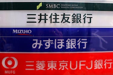 Signs for Japan's three mega banks, Sumitomo Mitsui Banking Corporation (top), Mizuho Bank (C) and Bank of Tokyo-Mitsubishi UFJ, are pictured in Tokyo May 15, 2013.