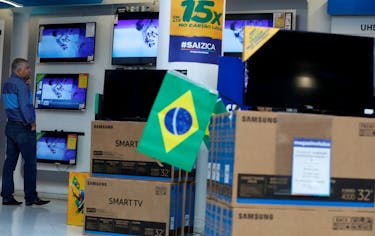 A man checks prices of television sets for sale in a store in Sao Paulo, Brazil June 1, 2018. Picture taken June 1, 2018.