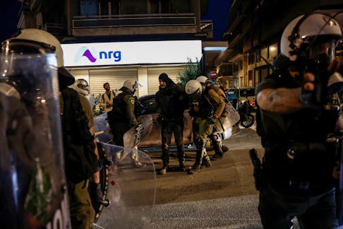 Riot police officers detain a demonstrator during a protest in solidarity with Palestine, amid the ongoing conflict between Israel and Palestinian Islamist group Hamas, near the Israeli embassy in Athens, Greece, May 15, 2024.