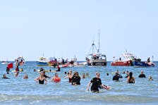 Protestors bathe in the sea, during a demonstration to demand that water companies stop chemical and untreated sewage dumps into the water, at Gwithian Beach, St. Ives, Cornwall, Britain, April 21, 2024.