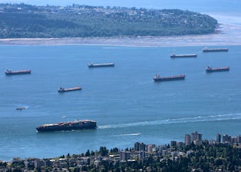 A container ship makes its way into the Port of Vancouver past vessels at anchor in English Bay, as seen from Grouse Mountain in North Vancouver, British Columbia, Canada May 10, 2024.