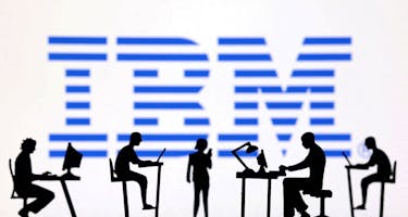 Figurines with computers and smartphones are seen in front of IBM logo in this illustration taken, February 19, 2024.