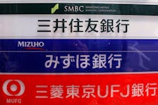 Signs for Japan's three mega banks, Sumitomo Mitsui Banking Corporation (top), Mizuho Bank (C) and Bank of Tokyo-Mitsubishi UFJ, are pictured in Tokyo May 15, 2013.