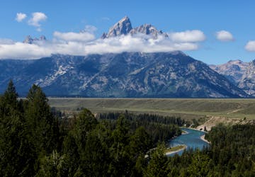 The Grand Tetons rise above the clouds in Grand Teton National Park where financial leaders from around the world are gathering for the Jackson Hole Economic Symposium, outside Jackson, Wyoming, U.S., August 25, 2022.