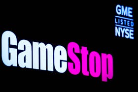 A screen displays the logo and trading information for GameStop on the floor of the New York Stock Exchange (NYSE) in New York City, U.S., March 29, 2022. 