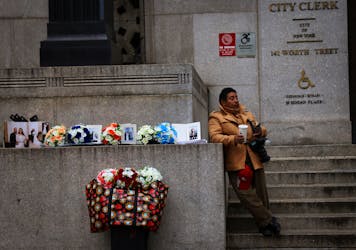A photographer hoping to sell pictures to newlyweds waits outside the office of the New York City City Clerk, where couples are married in civil ceremonies, in lower Manhattan, New York, U.S., March 23, 2023. REUTERS Mike Segar/File Photo