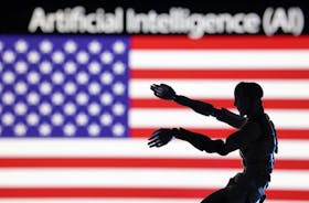 AI Artificial intelligence words, miniature of robot and U.S. flag are seen in this illustration taken December 21, 2023.