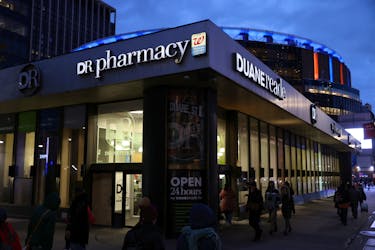 People walk by a Duane Reade pharmacy, owned by the Walgreens Boots Alliance, Inc., in Manhattan, New York City, U.S., November 26, 2021.