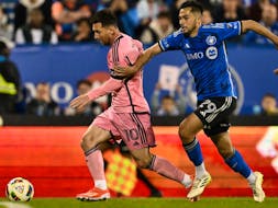  Lionel Messi dribbles the ball against Mathieu Choinière of CF Montréal during the second half at Saputo Stadium in Montreal May 11.