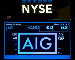 The ticker information for insurance company American International Group Inc., (AIG) is displayed on a screen above the post where it is traded on the floor of the New York Stock Exchange November 4, 2015.