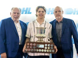 London Knight forward Easton Cowan is flanked by Ontario Hockey League commissioner David Branch (left) and team manager Mark Hunter after being awarded the Red Tilson Trophy as the league’s most outstanding player in London, Ont.,  on Thursday.

