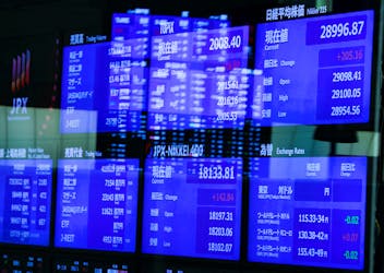 Monitors displaying the stock index prices and Japanese yen exchange rate against the U.S. dollar are seen after the New Year ceremony marking the opening of trading in 2022 at the Tokyo Stock Exchange (TSE), amid the coronavirus disease (COVID-19) pandemic, in Tokyo, Japan January 4, 2022.