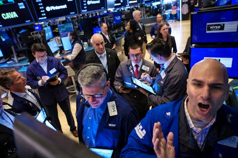 Traders work on the floor at the New York Stock Exchange (NYSE) in New York City, U.S., May 15, 2024. 