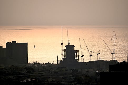 Construction work is seen as the sun sets, amid the ongoing conflict between Israel and the Palestinian Islamist group Hamas from Gaza, in Tel Aviv, Israel, February 27, 2024.