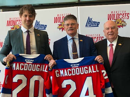 Moncton Wildcats president Robert K. Irving, right, welcomes new general manager Taylor MacDougall, left, and head coach Gardiner MacDougall to the Quebec Maritimes Junior Hockey League team during a news conference at the Avenir Centre on May 15. Gardiner is from Bedeque, P.E.I. Jason Simmonds • The Guardian