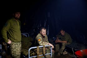 Ukrainian servicemen of the 42nd Separate Mechanized Brigade wait for a combat work inside a dugout at a position near a border, amid Russia's attack on Ukraine, in Kharkiv region, Ukraine May 16, 2024.