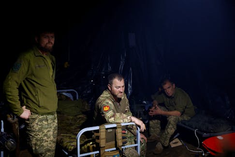 Ukrainian servicemen of the 42nd Separate Mechanized Brigade wait for a combat work inside a dugout at a position near a border, amid Russia's attack on Ukraine, in Kharkiv region, Ukraine May 16, 2024.
