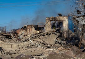 Rescuers work at the site of Russian air strikes, amid Russia's attack on Ukraine, in the village of Lyptsi, Kharkiv region, Ukraine April 10, 2024. 