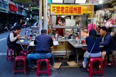 People eat in a restaurant at a night market in Taipei, Taiwan May 14, 2024.