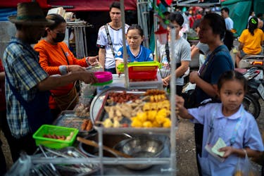 People buy street food at a market as Thailand is to inject $15.2 bln into economy next year through its digital wallet policy, in Bangkok, Thailand, October 2, 2023.