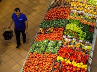 A shopper walks past produce at a grocery store in Toronto, Ontario, Canada, on Thursday, Sept. 1, 2022. 