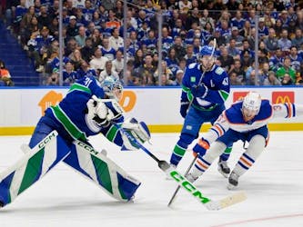  Arturs Silovs #31 of the Vancouver Canucks clears the puck under pressure from Warren Foegele #37 of the Edmonton Oilers during the second period in Game Five of the Second Round of the 2024 Stanley Cup Playoffs at Rogers Arena on May 16, 2024 in Vancouver, British Columbia.