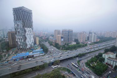 An uncompleted building is seen next to the Fourth Ring Road in Beijing, China July 16, 2018.