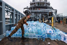 Brazilian soldier carries donations from a navy ship at the Guaiba Lake in Porto Alegre, state of Rio Grande do Sul, Brazil May 16, 2024.REUTERS/Diego Vara
