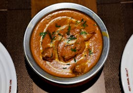 A freshly prepared butter chicken dish is placed on a table inside the Moti Mahal Delux restaurant in New Delhi, India, January 23, 2024.