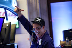 A trader wearing The Dow .DJI hat works on the floor at the New York Stock Exchange (NYSE) in New York City, U.S., May 16, 2024. 