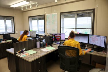 Alberta Wildfire dispatchers take radio calls and help coordinate helicopters during a media tour of the incident command post two days after a wildfire caused the evacuation of communities on the southern edge of Fort McMurray, Alberta, Canada May 16, 2024.