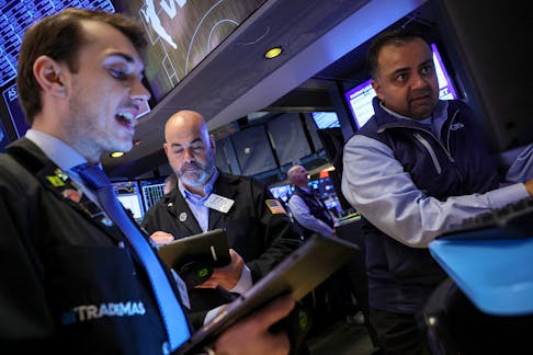 Traders work on the floor at the New York Stock Exchange (NYSE) in New York City, U.S., May 17, 2024. 