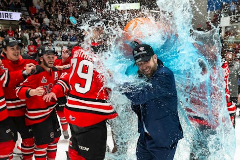 Drummondville Voltigeurs head coach Sylvain Favreau gets a Gatorade shower from his players after winning the Gilles Courteau Trophy in Drummondville on Tuesday. - QMJHL