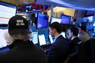 A trader wearing The Dow .DJI hat works on the floor at the New York Stock Exchange (NYSE) in New York City, U.S., May 16, 2024. 