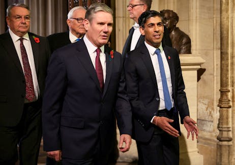 Labour Party leader Sir Keir Starmer walks with Britain's Prime Minister Rishi Sunak during the State Opening of Parliament ceremony, at the Houses of Parliament, in London, Britain November 7, 2023.