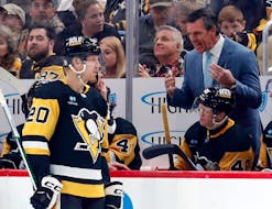 Dec 18, 2023; Pittsburgh, Pennsylvania, USA;  Pittsburgh Penguins head coach Mike Sullivan (right) talks with center Lars Eller (20) at the bench against the Minnesota Wild during the third period at PPG Paints Arena. Pittsburgh won 4-3. Mandatory Credit: Charles LeClaire-USA TODAY Sports/File Photo