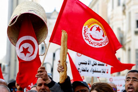 A person holds up a baguette as supporters of the Tunisian General Labour Union (UGTT) protest against President Kais Saied, accusing him of trying to stifle basic freedoms, including union rights, in Tunis, Tunisia March 4, 2023.
