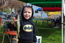 Four-year-old Jack White holds a roughly foot-long speckled trout he caught at Wentworth Park on Saturday. White was one of an estimated more than 100 fishing derby participants at the Sydney park on Saturday. LUKE DYMENT/CAPE BRETON POST