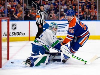 The Edmonton Oilers' Dylan Holloway (55) scores on Vancouver Canucks' goalie Arturs Silovs (31) during first period NHL playoff action at Rogers Place, in Edmonton Saturday May 18, 2024. 