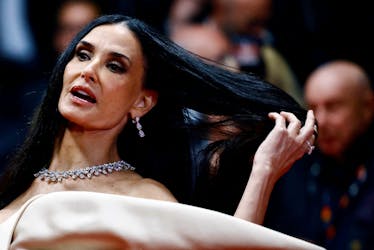 Cast member Demi Moore poses on the red carpet during arrivals for the screening of the film "The Substance" in competition at the 77th Cannes Film Festival in Cannes, France, May 19, 2024.