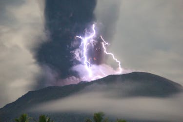 Lightning appears amid a storm as Mount Ibu spews volcanic material during an eruption, as seen from Gam Ici in West Halmahera, North Maluku province, Indonesia, May 18, 2024 in this handout image. The Center for Volcanology and Geological Hazard Mitigation (PVMBG)/Handout via REUTERS