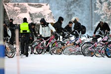 Migrants arrive with bicycles to the international border crossing at Salla, northern Finland, November 23, 2023.  Lehtikuva/Jussi Nukari via
