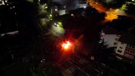 A car is seen lit on fire, amid protests against plans to allow more people to take part in local elections in the French-ruled territory, which indigenous Kanak protesters reject, in Noumea, New Caledonia May 18, 2024 in this screengrab from video obtained by Reuters/via REUTERS