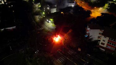 A car is seen lit on fire, amid protests against plans to allow more people to take part in local elections in the French-ruled territory, which indigenous Kanak protesters reject, in Noumea, New Caledonia May 18, 2024 in this screengrab from video obtained by Reuters/via REUTERS
