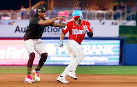 May 18, 2024; Miami, Florida, USA;  Miami Marlins pitcher Edward Cabrera (42) chases third baseman Otto Lopez (61) after he had the winning hit in extra innings against the New York Mets  at loanDepot Park. Mandatory Credit: Rhona Wise-USA TODAY Sports