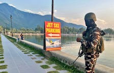 An Indian security force personnel stands guard on the banks of Dal Lake, one of Kashmir's main tourist attractions, in Srinagar, India July 6, 2023.